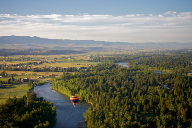 hot air balloon floating over bitterroot river, montana