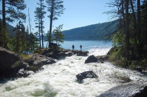 inlet of lake como, montana with two fishermen