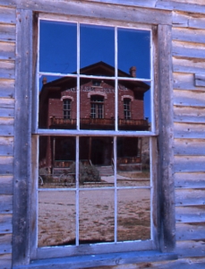 hotel meade in bannack state park reflected in window