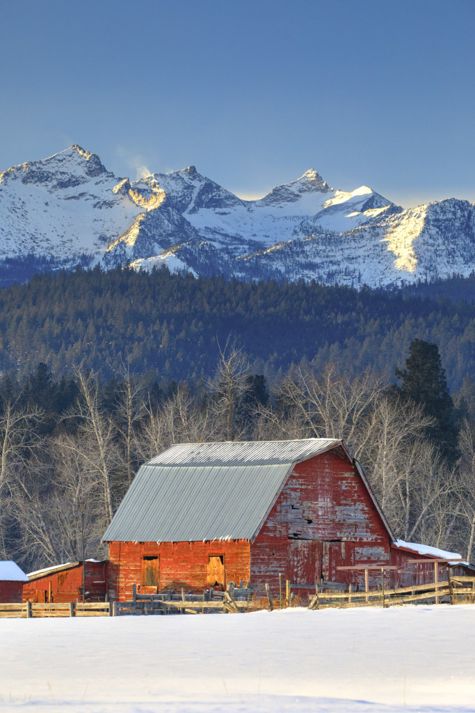 red barn with como peaks behind in snow