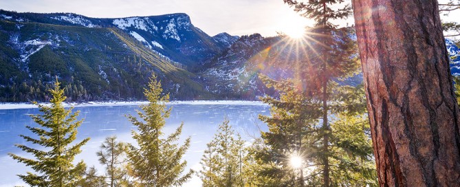 Lake Como Montana frozen in winter at sunset